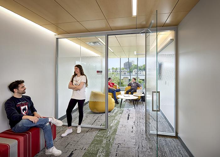 student inside and outside a forbes beeler study lounge with lots of natural light